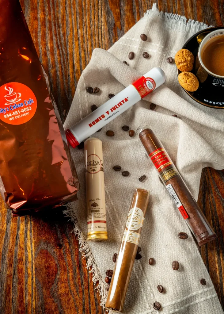 Ody's Cuban coffee bag, espresso and premium cigars on a rustic wooden table